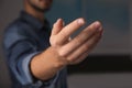 Man offering helping hand on blurred background Royalty Free Stock Photo