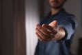 Man offering helping hand on blurred background, closeup Royalty Free Stock Photo