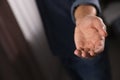 Man offering helping hand on blurred background, closeup. Royalty Free Stock Photo