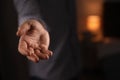 Man offering helping hand on blurred background, closeup Royalty Free Stock Photo