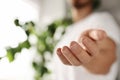 Man offering helping hand on blurred background, closeup Royalty Free Stock Photo
