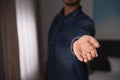 Man offering helping hand on blurred background. Space for text Royalty Free Stock Photo