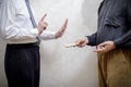 Man Offering a Hryvnia Bribe to a Man Refusing It Royalty Free Stock Photo