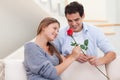 Man offering a rose to his wife Royalty Free Stock Photo