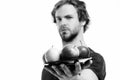 Man offers apples. Young sexy macho with strong face expression holding plate full of red and yellow apple fruit Royalty Free Stock Photo