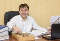 A man in an office laughing pointing at an abacus