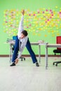 The man in the office with many conflicting priorities doing exercises