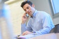 Man in office with mobile phone Royalty Free Stock Photo