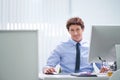 Man, office and portrait with computer and desk, happy and confident corporate male person sitting in workspace Royalty Free Stock Photo