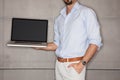 Man in office showing his presentation on laptop