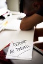 Man at office and text back to work in french Royalty Free Stock Photo