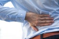 Man in office uniform having back pain issue / back injury