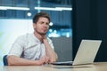 Man in office at work, tired has neck pain, young businessman in shirt works with laptop unhealthy Royalty Free Stock Photo