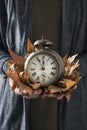 Man with old alarm clock and dry leaves Royalty Free Stock Photo