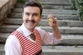 Man with old fashioned elegant look holding wooden spinning top