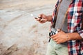 Man with old vintage photo camera using cell phone Royalty Free Stock Photo