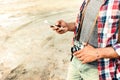 Man with old vintage photo camera using cell phone Royalty Free Stock Photo