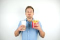 Man with one french fries under his nose and holds soda in papper cup and fries from fast food restaurant looks funny on Royalty Free Stock Photo