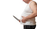 A man with one hand holds the fat fold on his big belly, and in Royalty Free Stock Photo