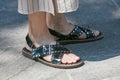 Man with open black leather sandals with studs before Emporio Armani fashion show, Milan Fashion Week street