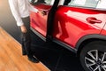 Man open red car door with smart keyless For automotive or transportation image Royalty Free Stock Photo