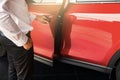 Man open red car door with smart keyless For automotive or transportation image Royalty Free Stock Photo