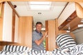 Man open wooden door in campervan motorhome during vanlife vacation in RV