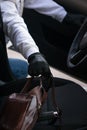 Man opened the door of the car and wants to steal someone else`s things