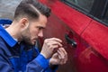 Man Opening Car Door With Lockpicker Royalty Free Stock Photo