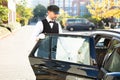 Man opening car door while woman sitting in car Royalty Free Stock Photo