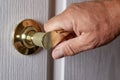 Man opening door in home.Closeup photo of metal door handle in modern style Royalty Free Stock Photo