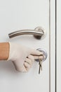 Man opening a door wearing latex gloves Royalty Free Stock Photo