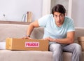 Man opening fragile parcel ordered from internet