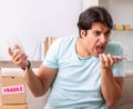 Man opening fragile parcel ordered from internet