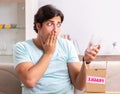 Man opening fragile parcel ordered from internet