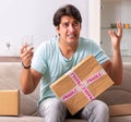 Man opening fragile parcel ordered from internet