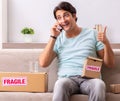 Man opening fragile parcel ordered from internet