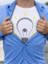 Man opening his shirt with lightbulb printed on it Royalty Free Stock Photo