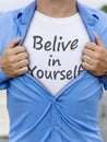 Man opening his shirt with quote Belive in yourself