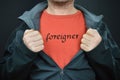 Man opening jacket showing word FOREIGNER