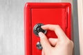 Man opening steel safe with mechanical combination lock, closeup