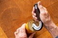 Man opening a tin can with a special opener Royalty Free Stock Photo