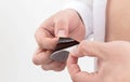 A man opens an anti-smoking plaster in his hands, close-up. Nicotine addiction, protection Royalty Free Stock Photo