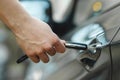 A man opens a car door with a key, close-up hand. Dead battery in remote key