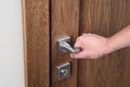 The man opens the door. Close - up of hand and door handle