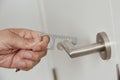 Man opens a door with a non-contact opener device Royalty Free Stock Photo