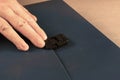 Man opens lock of blue briefcase for papers. Closed flexible bri