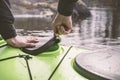 The man opens a sealed hatch cover for things in the kayak that