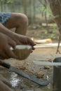 Man opens tropical coconuts at home with home knife