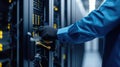 A man operates an electric blue server in a glass data center. AIG41 Royalty Free Stock Photo